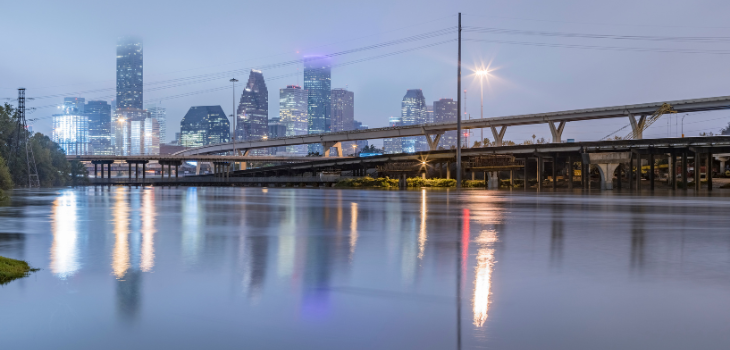 Streets covered in floodwaters, with the Houston skyline in the background.