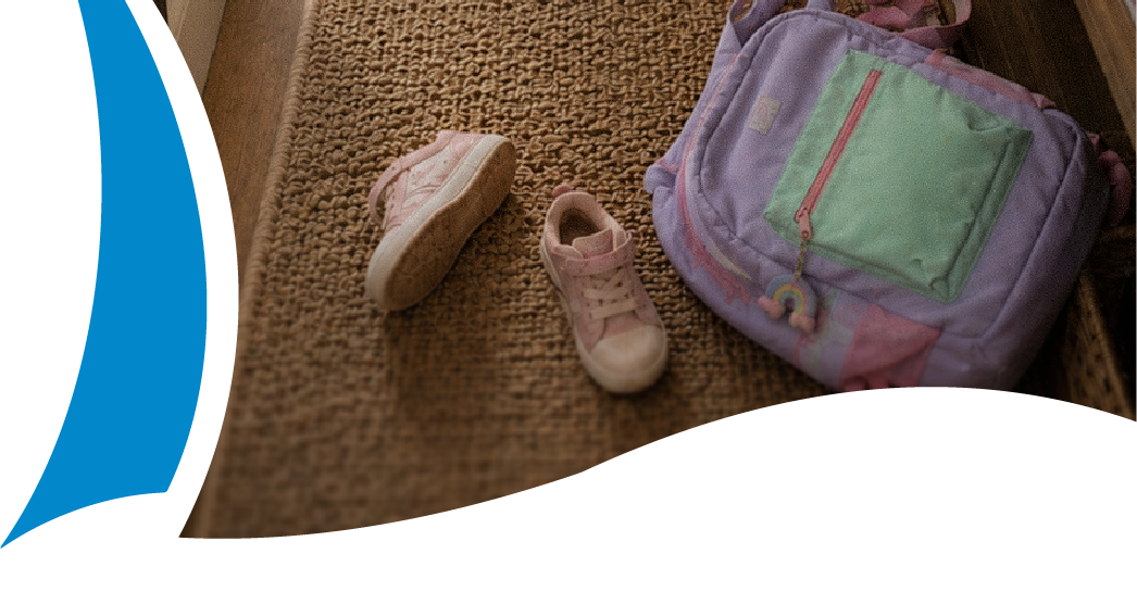 A child's backpack and shoes at your front door.
