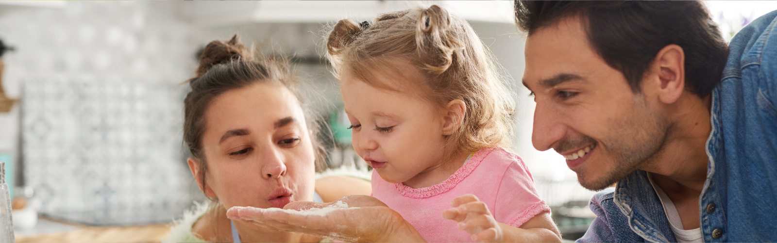 parents baking with young daughter