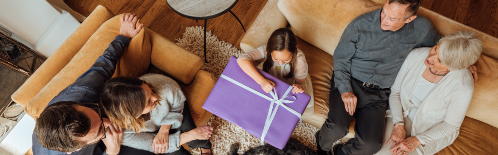 A family opens a Christmas gift.